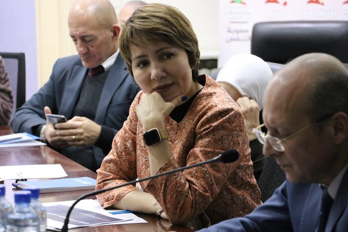Dr Akjemal Magtymova at a meeting table, listening, with colleagues beside her